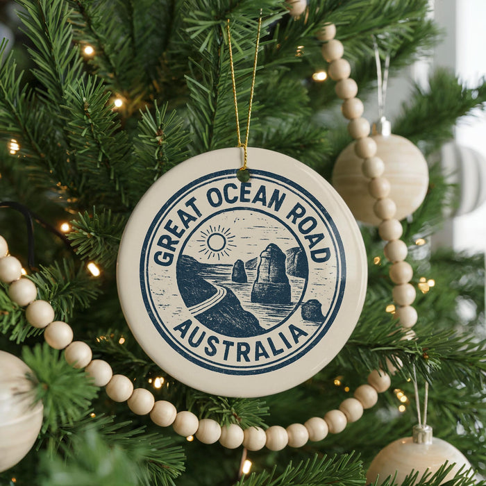 A Christmas tree decorated with ornaments, including a circular ornament with the text "GREAT OCEAN ROAD AUSTRALIA" and a sun graphic.