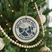 A Christmas tree decorated with ornaments, including a circular ornament with the text "GREAT OCEAN ROAD AUSTRALIA" and a sun graphic.