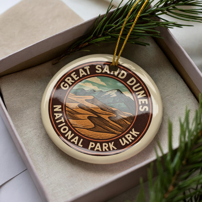 A circular ornament with the text "GREAT SAN DIEGO DUNES NATIONAL PARK URK" printed on it, surrounded by pine branches.