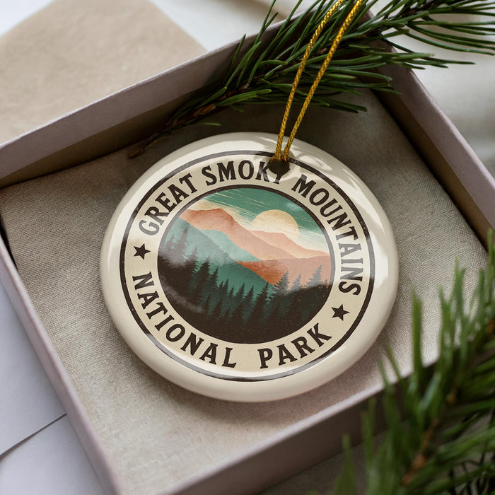 A circular ornament with the text "GREAT SMOKY MOUNTAINS NATIONAL PARK" printed on it, surrounded by pine branches.