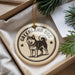 A circular ornament featuring a black and white illustration of a husky dog, with the text "GREENLAND DOG" around the edge.