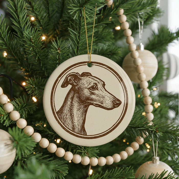 A Christmas tree decorated with ornaments, including a circular ornament featuring a dog's head.