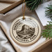 A circular ornament with the text "GUADALUPE MOUNTAINS NATIONAL PARK" printed on it, hanging from a string.