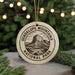 A circular ornament with the text "GUADALUPE MOUNTAINS NATIONAL PARK" and an illustration of a mountain range.