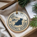 A decorative ornament with the text "GUERNSEY CHANNEL ISLANDS" printed on it, hanging from a string.