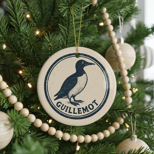 A Christmas tree decorated with ornaments, including a circular ornament with a bird image and the word "GUILLLEMOT" written on it.