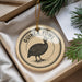 A decorative ornament featuring a guinea fowl, with the text "GUINEA FOWL" printed on it, is displayed in a box with pine branches.