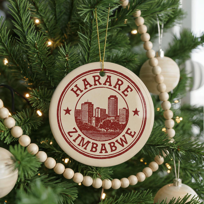 A Christmas tree decorated with ornaments, including a circular ornament with the text "HARARE ZIMBABWE" printed on it.