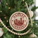 A Christmas tree decorated with ornaments, including a circular ornament with the text "HARARE ZIMBABWE" printed on it.