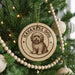 A round ornament on a Christmas tree featuring a dog image, with the text "HAVANESE DOG" around the edge.