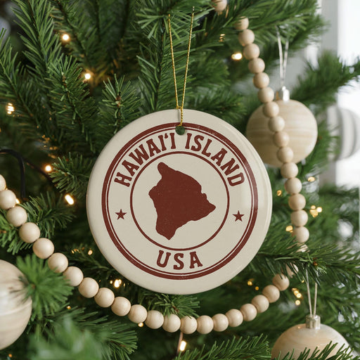A Christmas tree decorated with ornaments, including a circular ornament with the text "HAWAII'I ISLAND USA" and a wooden bead decoration.