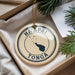 A circular ornament with the text "HA'APAI TONGA" printed on it, surrounded by pine branches.