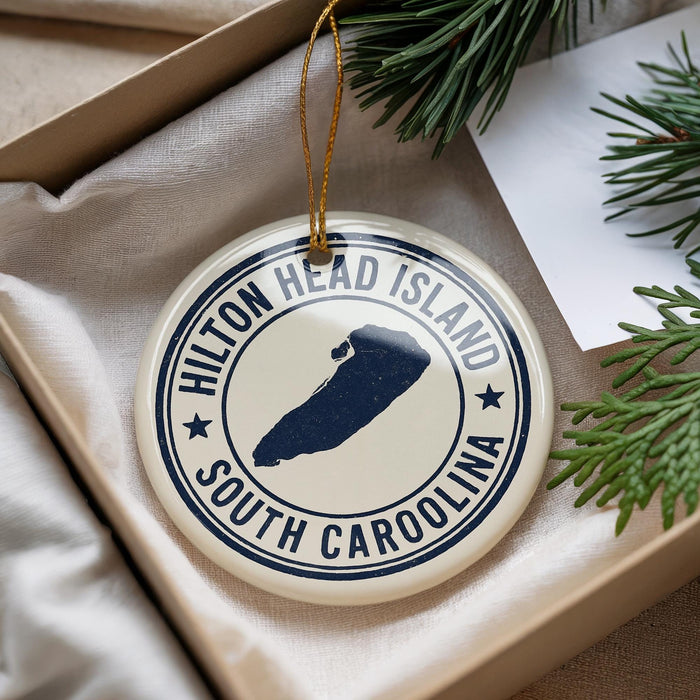 A round ornament with the text "Hilton Head Island South Carolina" printed on it, hanging from a string.