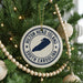 A Christmas tree decorated with ornaments, including a circular ornament with the text "Hilton Head Island, South Carolina" and a silhouette of a boat.
