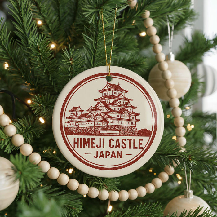 A Christmas tree decorated with ornaments, including a circular ornament with the text "Himeji Castle Japan" and a traditional Japanese temple illustration.