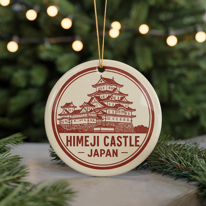 A circular ornament with a red and white design featuring a castle, surrounded by Christmas lights and greenery.