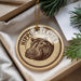 A circular ornament with a hippopotamus image and the text "HIPPOPOTAMUS" is displayed in a box, surrounded by pine branches.