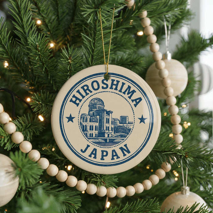 A circular ornament on a Christmas tree, featuring the text "HIrosawa Japan" and an illustration of a building.