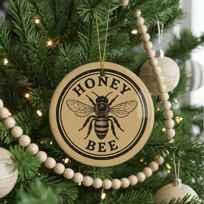 A round ornament on a Christmas tree with the text "HONEY BEE" and a bee illustration.