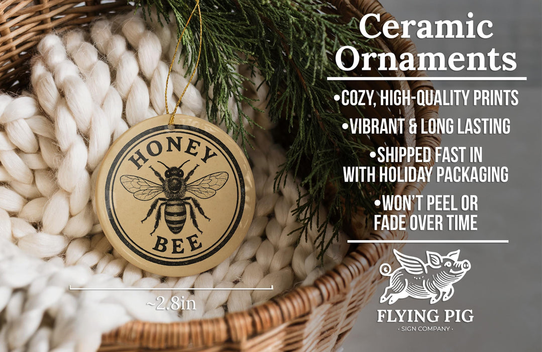 Ceramic ornaments, including a honey bee ornament, are displayed in a woven basket.
