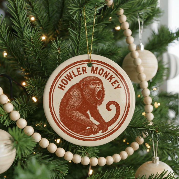 A Christmas tree decorated with ornaments, including a round ornament with a monkey image and the text "HOWLER MONKEY" on it.