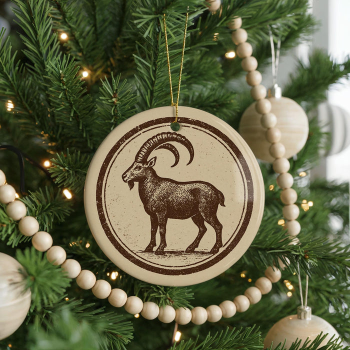 A Christmas tree decorated with ornaments, including a circular ornament featuring a goat and a string of wooden beads.