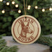 A circular ornament featuring a dog's head and the text "IRIZAN HOUND" is displayed in front of a Christmas tree with twinkling lights.