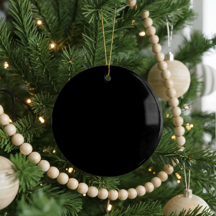 A Christmas tree decorated with ornaments, including a black ornament hanging from the branches.
