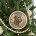A circular ornament on a Christmas tree featuring an image of an Irish Wolfhound dog.