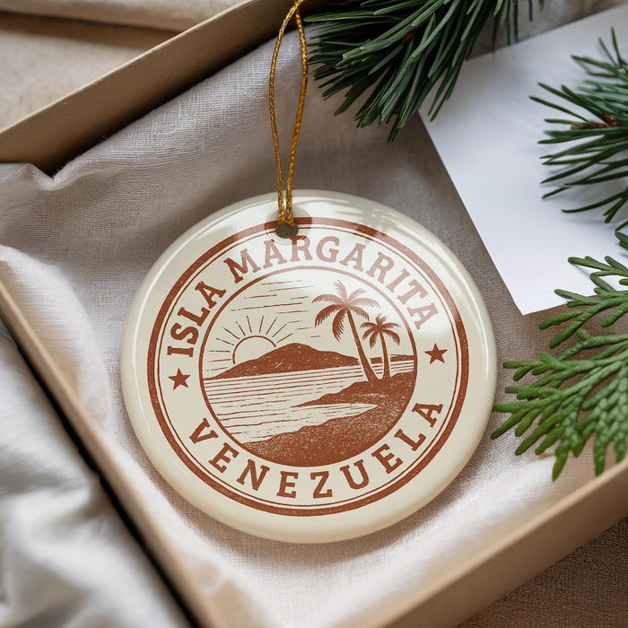 A circular ornament with the text "ISLA MARGARITA VENEZUELA" printed on it, surrounded by a decorative string and pine branches.