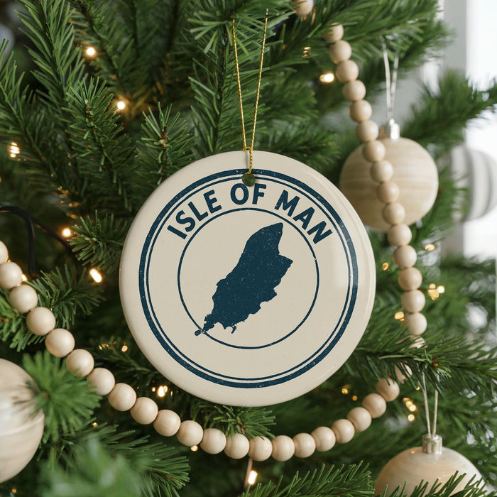 A Christmas tree decorated with ornaments, including a circular ornament with the text "ISLE OF MAN" and a silhouette of the island of Jersey.