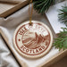 A circular ornament with the text "ISLE OF SKYE SCOTLAND" printed on it, surrounded by pine branches.