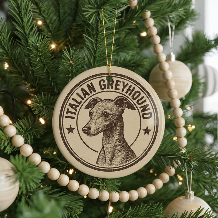 A Christmas tree decorated with ornaments, including a circular ornament with an illustration of an Italian Greyhound dog and the text "ITALIAN GREYHOUND".