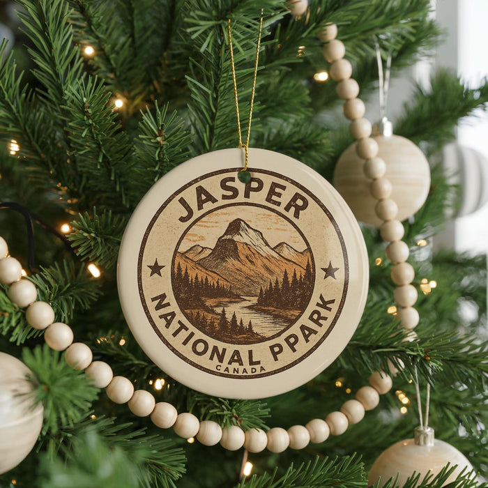 A Christmas tree decorated with a round ornament that says "JASPER NATIONAL PARK CANADA".