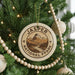A Christmas tree decorated with a round ornament that says "JASPER NATIONAL PARK CANADA".