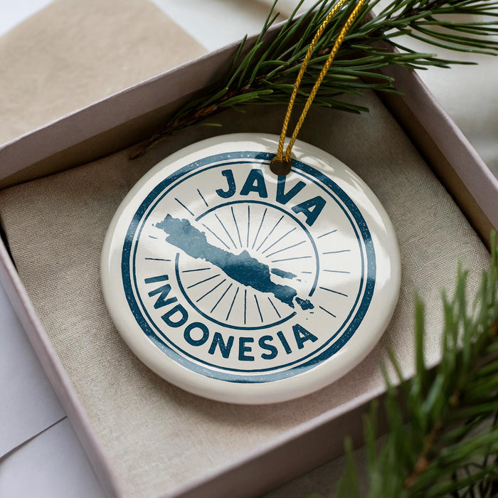 A circular ornament with the text "JAMAICA INDONESIA" printed on it, surrounded by pine branches.
