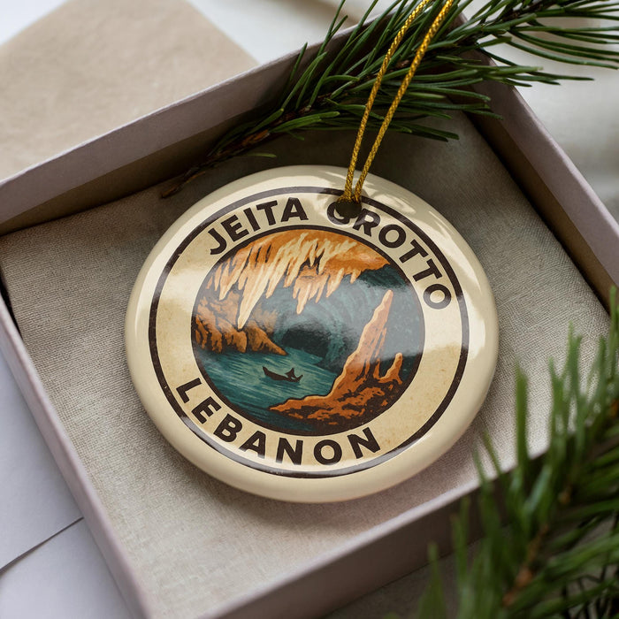 A circular ornament with the text "JEITA CROTTO LEBANON" printed on it, surrounded by a border and a depiction of a cave scene.