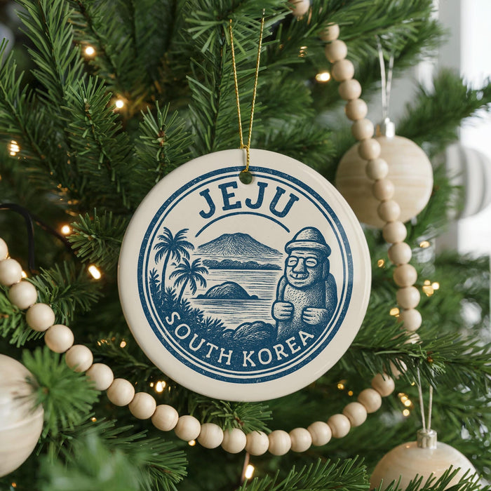 A Christmas tree decorated with ornaments, including a circular ornament with the text "Jeju South Korea" and a palm tree illustration.