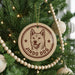 A Christmas tree decorated with ornaments, including a circular ornament with a dog's face and the text "JINDO DOG" printed on it.