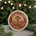 A circular ornament with the text "JOSHUA TREE NATIONAL PARK USA" printed on it, featuring a desert landscape with a Joshua tree.