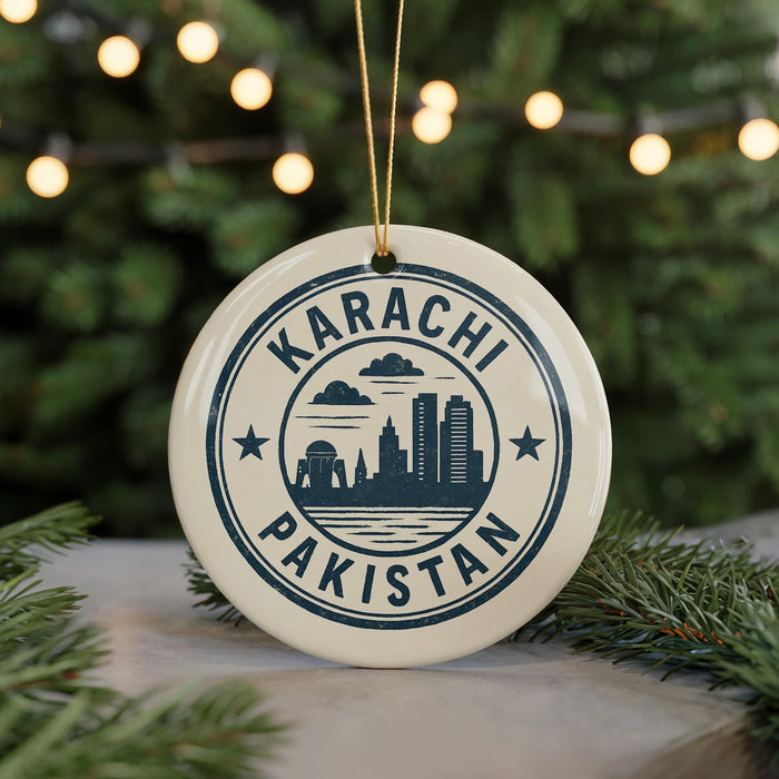 A circular ornament with the text "KARACHI PAKISTAN" and a graphic of a city skyline, hanging from a string.