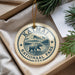 A circular ornament with the text "KATMAI NATIONAL PARK USA" and an illustration of a bear walking on a path, hanging from a string.
