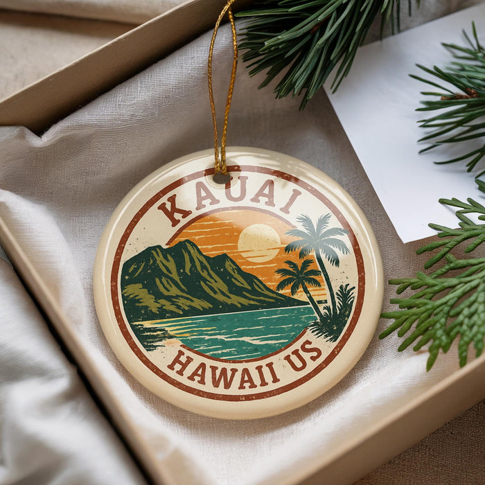 A circular ornament with the text "HAWAII US" and an illustration of a tropical landscape with mountains, palm trees, and a sunset.