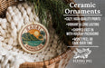 a ceramic ornament hanging from a wicker basket, with a pine branch and greenery in the background. The ornament has a circular design with a palm tree and a sunset, and it is described as a "Ceramic Ornaments" with various features such as "Cozy, high-quality prints", "Vibrant & long lasting", "Shipped fast in", "with holiday packaging", "won't peel or fade over time", and "2.8in".