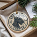 A circular ornament with a black and white illustration of a terrier dog, surrounded by stars, and the text "Kerr Blue Terrier" on it.