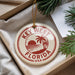A decorative ornament with the text "KEY WEST FLORIDA USA" printed on it, hanging from a string.