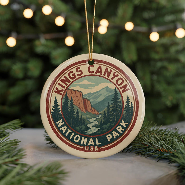 A circular ornament with the text "Kings Canyon National Park" and a mountain landscape design, hanging from a string.