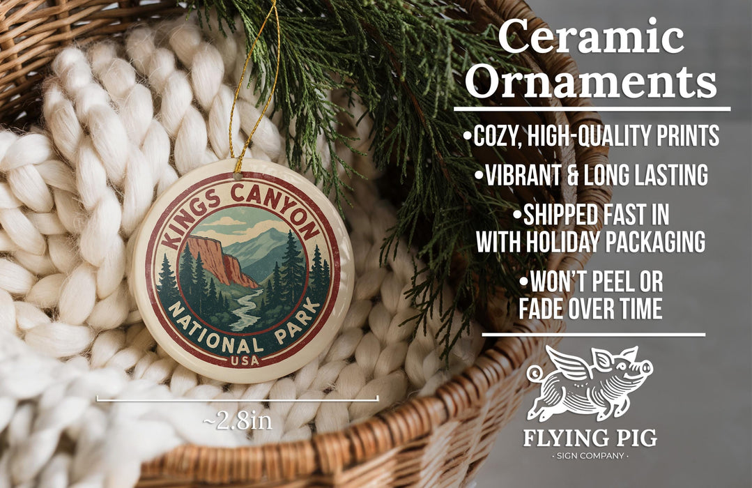 Ceramic ornaments, specifically the Kings Canyon National Park ornament, are displayed in a woven basket. The ornament features a mountain landscape and pine trees, and it is described as a cozy, high-quality print with vibrant and long-lasting colors. The ornament is shipped fast in holiday packaging and does not peel or fade over time. The image also includes a scale for the ornament, indicating it is 2.8 inches in diameter.