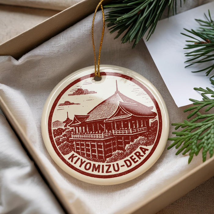 A circular ornament with a red and white design depicting a temple, hanging from a string.