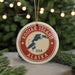 A circular ornament with the text "KODIAK ISLAND USA" and a map of Alaska, surrounded by Christmas lights and greenery.